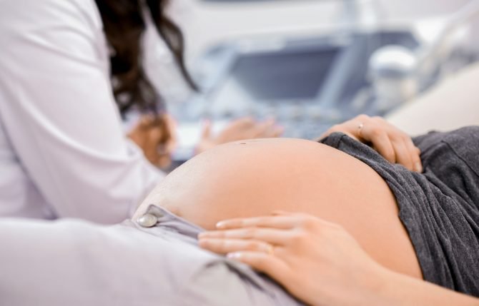 doctor-performing-ultrasound-scanning-for-her-pregnant-patient-(1)